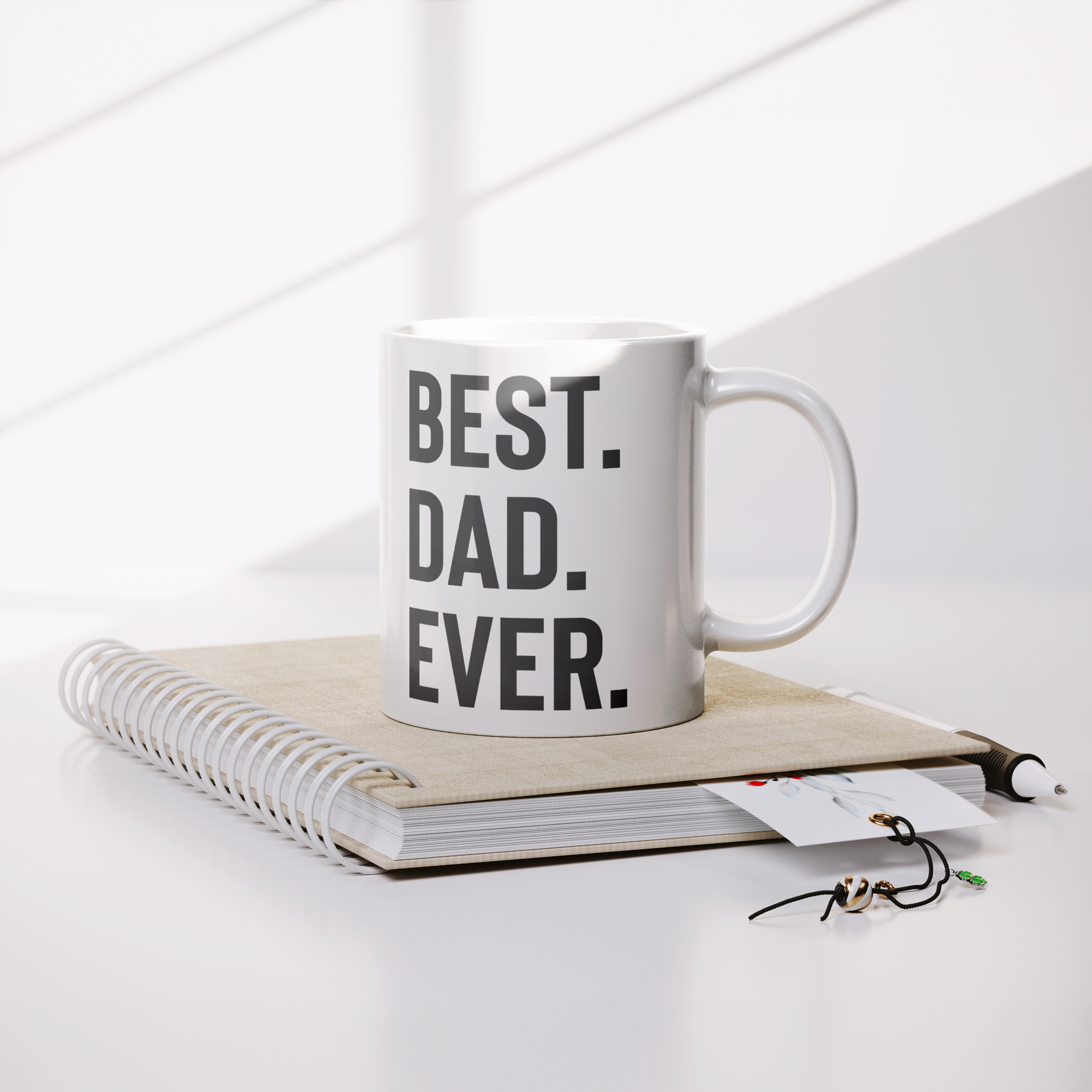 Best_Dad_Ever_Mug__11oz_White_Ceramic_Lifestyle_Notebook_Mockup.png