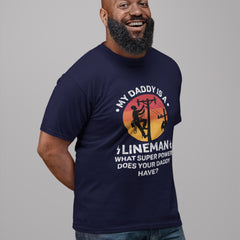 My Daddy Is A Lineman T-Shirt featuring vintage lineman silhouette climbing utility pole with sunset background