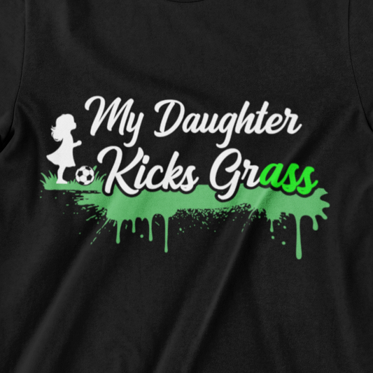 My Daughter Kicks Grass T-shirt – Bold design with a girl kicking a soccer ball and green grass splashes, perfect for proud soccer parents.