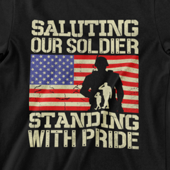 ‘Saluting Our Soldier Standing With Pride’ text, American flag background, and soldier silhouette with saluting family