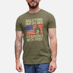 ‘Saluting Our Soldier Standing With Pride’ text, American flag background, and soldier silhouette with saluting family