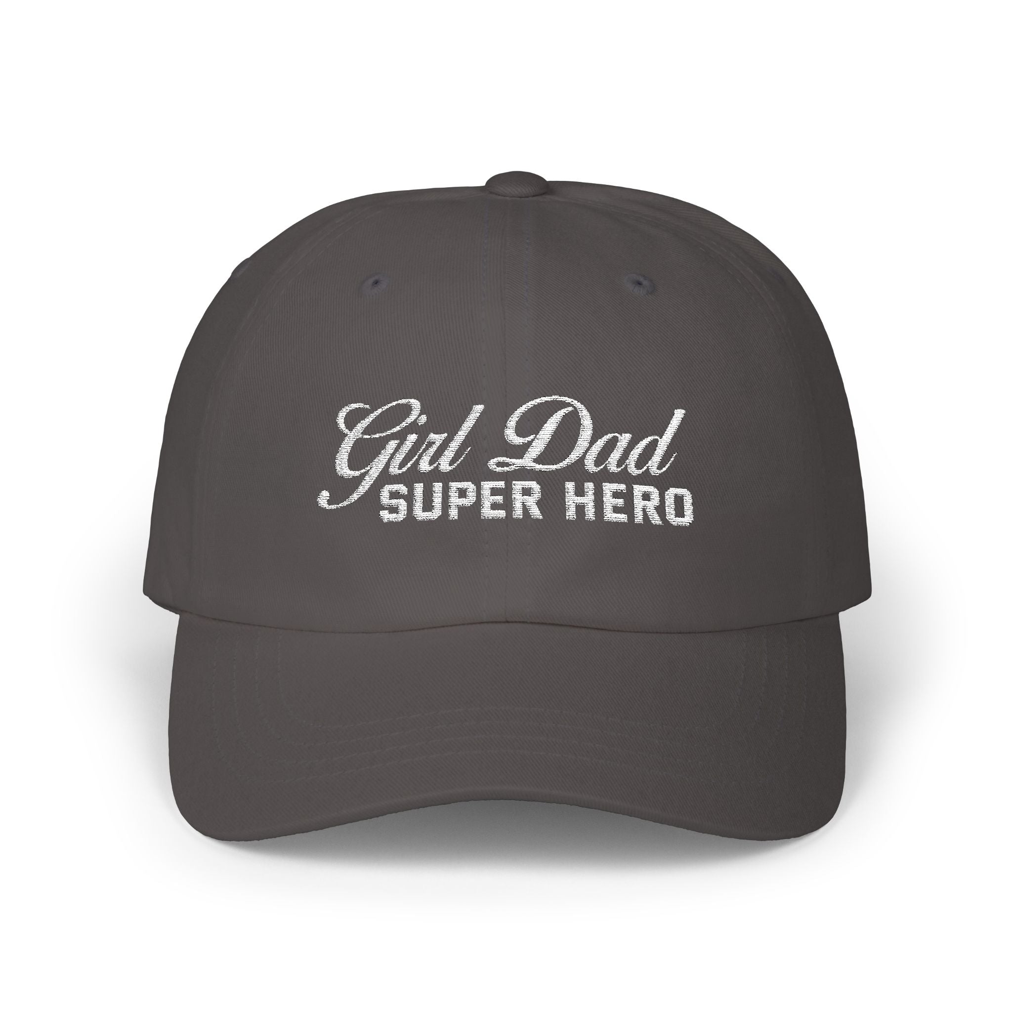 Woman wearing a black hat with mixed-script embroidered text reading “Girl Dad Super Hero” standing against a chain-link fence