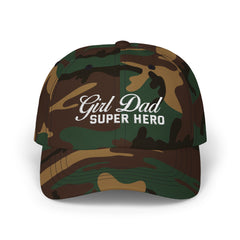 Woman wearing a black hat with mixed-script embroidered text reading “Girl Dad Super Hero” standing against a chain-link fence