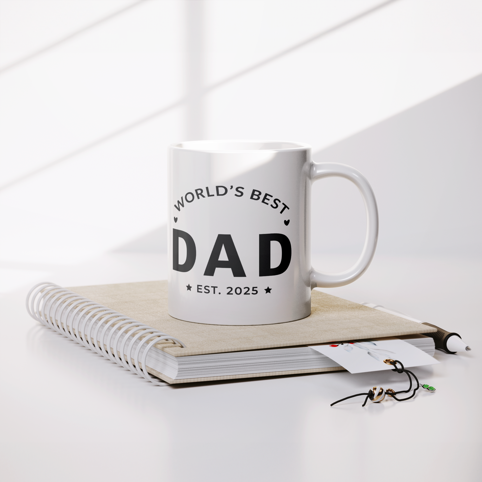 Worlds_Best_Dad_Est_2025_Mug_-_New_Dad_Lifestyle_Notebook_Mockup.png